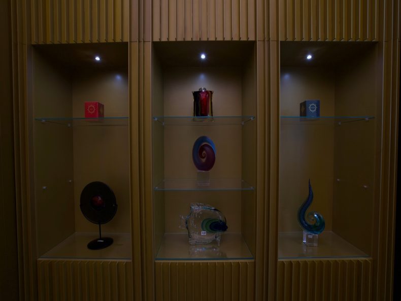 Timber display niches with feature lighting in the Ajmal Perfumes boutique at Westfield London